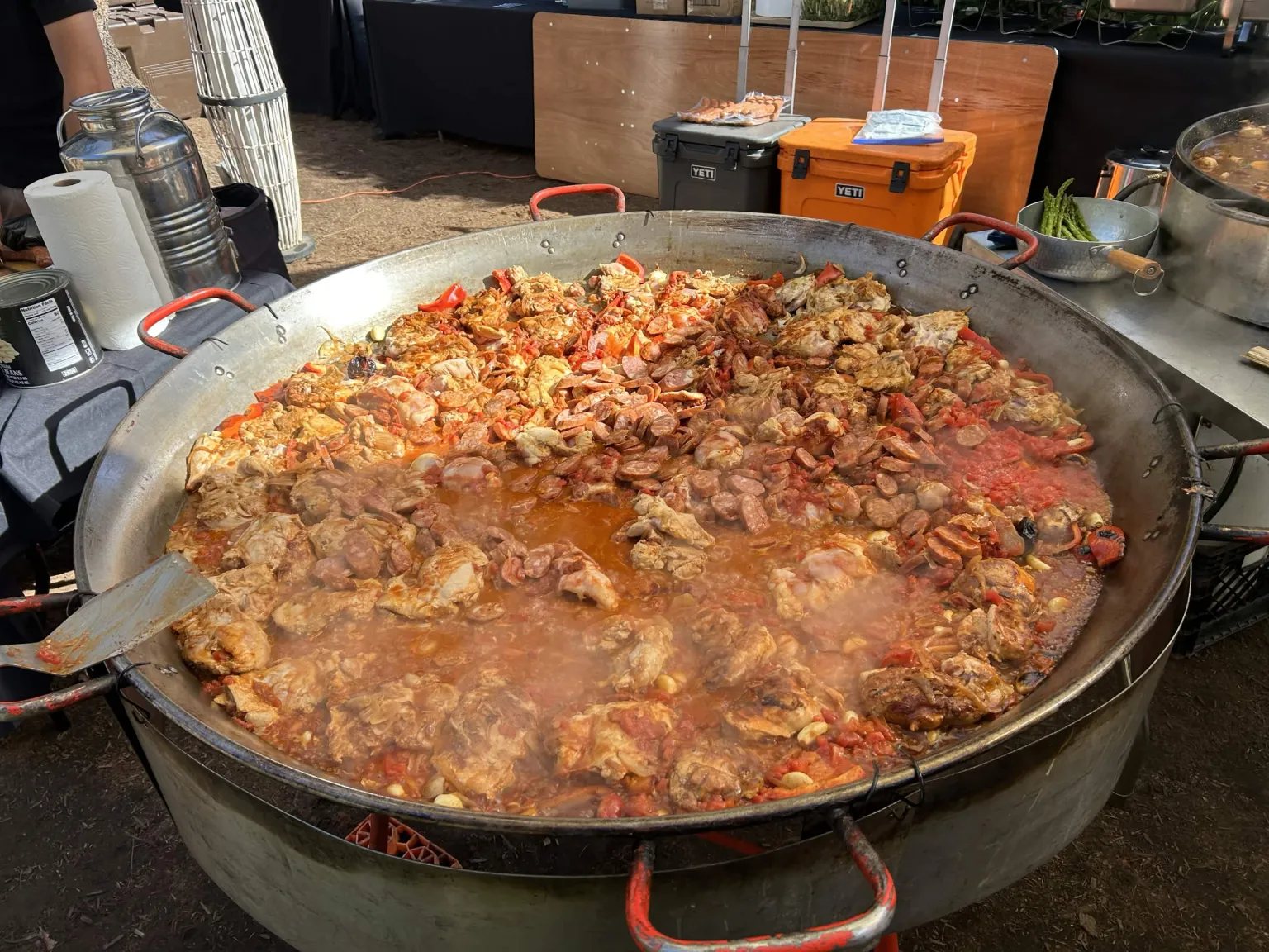 A large pan of paella cooking for campers